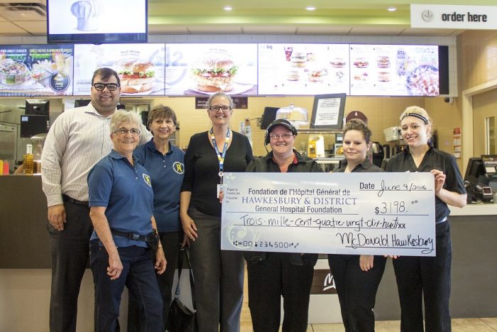 McDonald's employees hand over a big cheque to HGH Foundation representatives