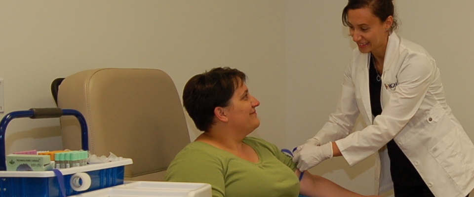 Nurse preparing patient for blood work in Specimen Collection Centre